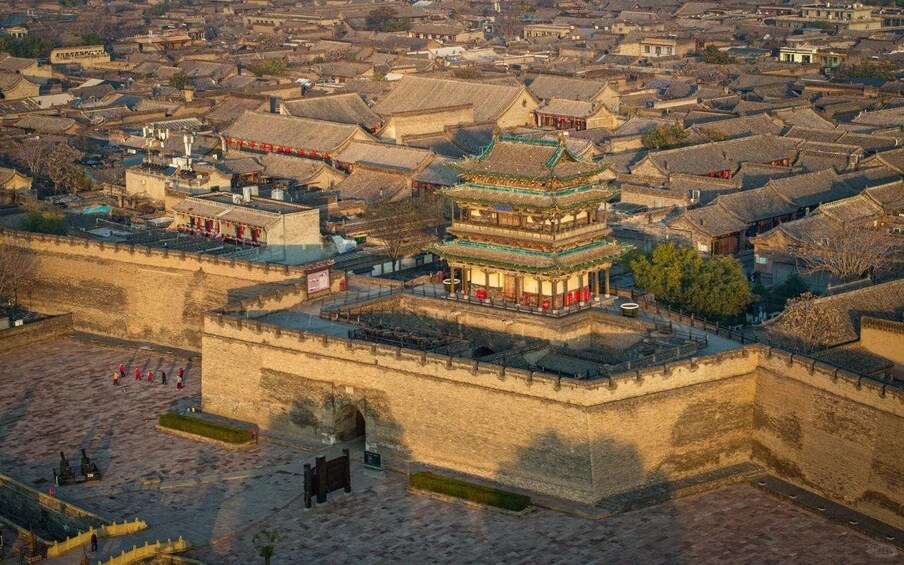A traditional Chinese cityscape with a prominent multi-tiered pagoda and surrounding ancient buildings. 4