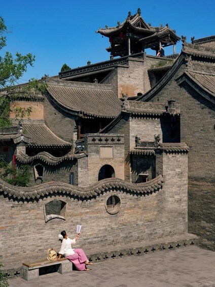 A traditional Chinese building with ornate architecture, including curved roofs and intricate designs. 3