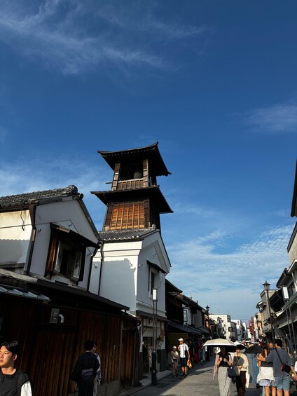 A traditional Japanese street with wooden buildings and a pagoda. 2
