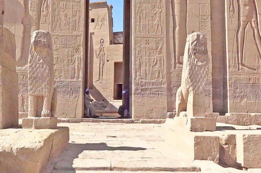 Ancient Egyptian sphinx statues, hieroglyphics, and a doorway leading to a temple interior. 1