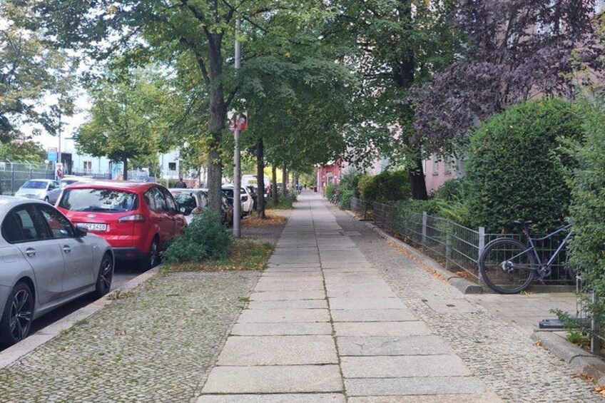 A paved sidewalk, parked cars, and a bicycle. 5