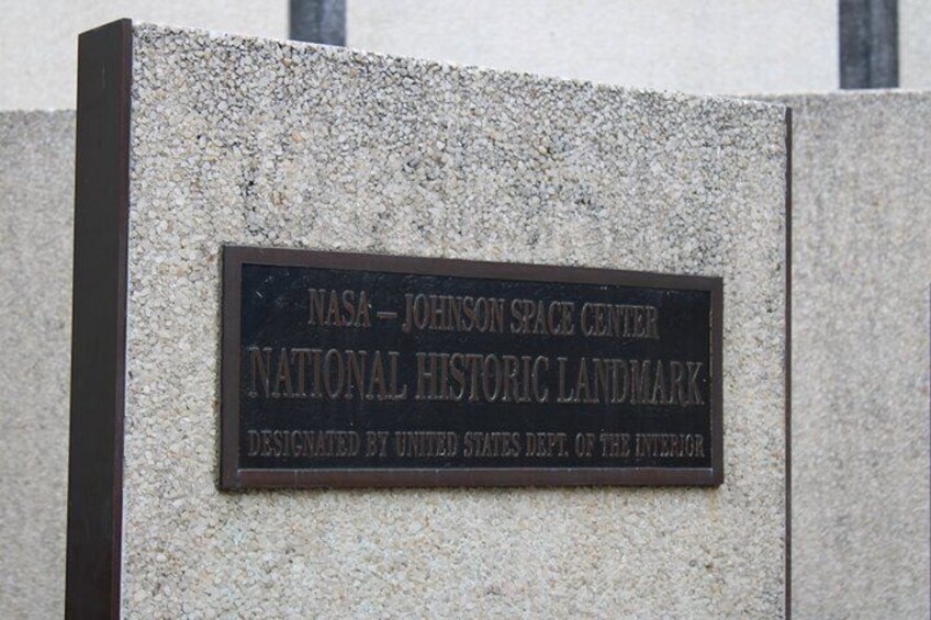 A plaque on a stone wall. 1