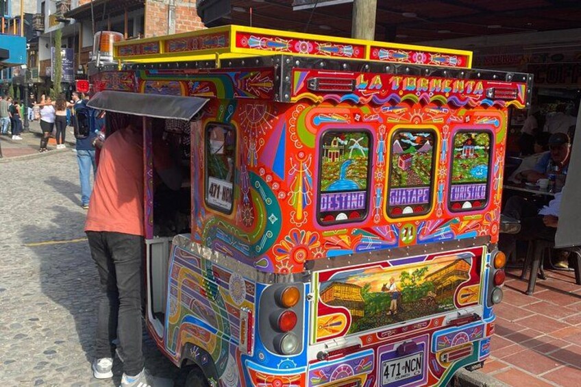 A colorful, decorated bus with the words 'LA TORRENTA' and 'DESTINO' on it. 5