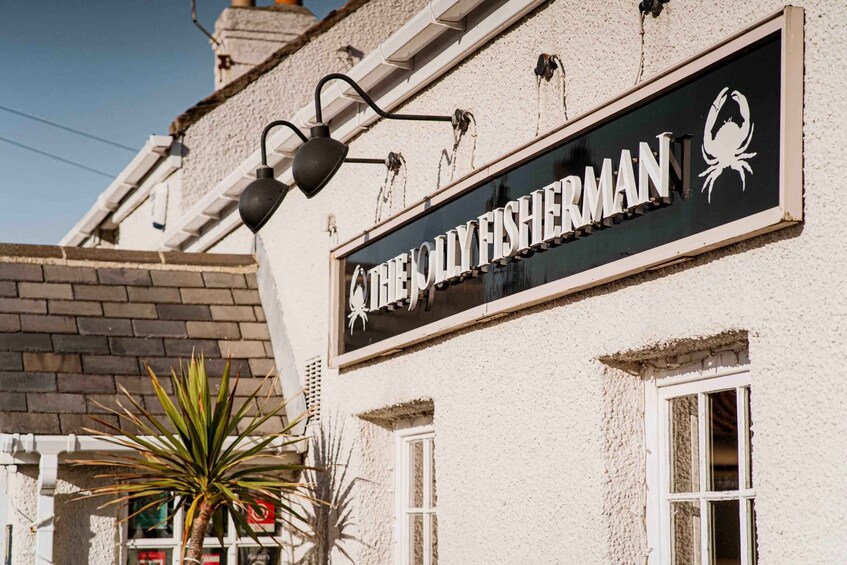 A building with a sign that reads 'THE OLD FISHERMAN' and a crab logo. 5