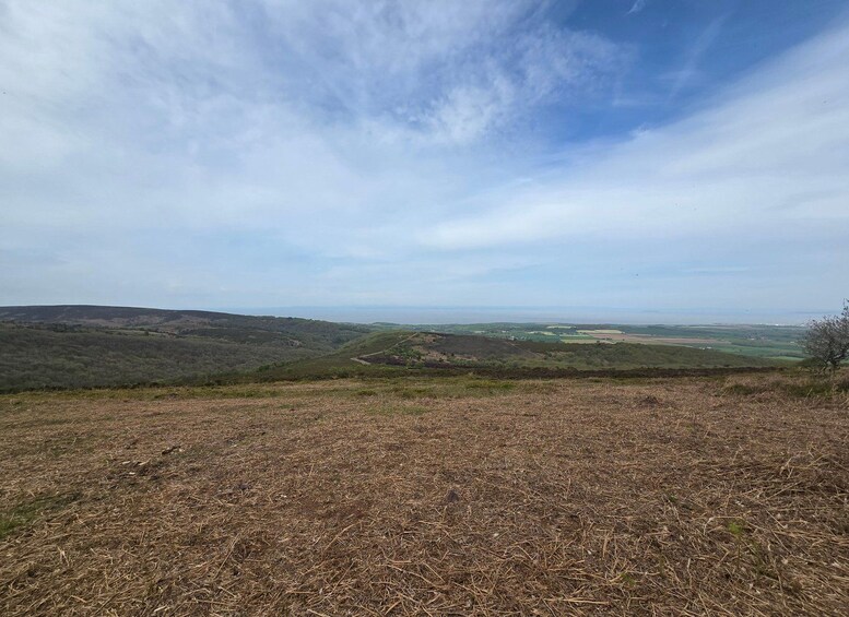 A hilly landscape with a clear sky. 1