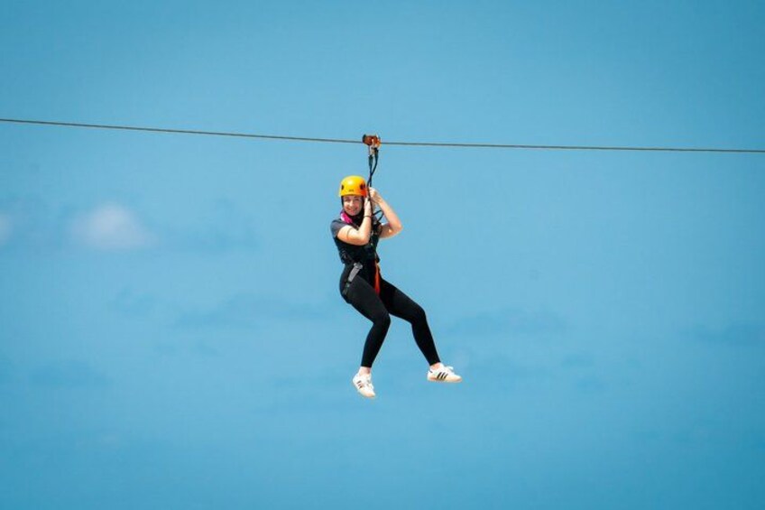 A person zip-lining through the air. 3