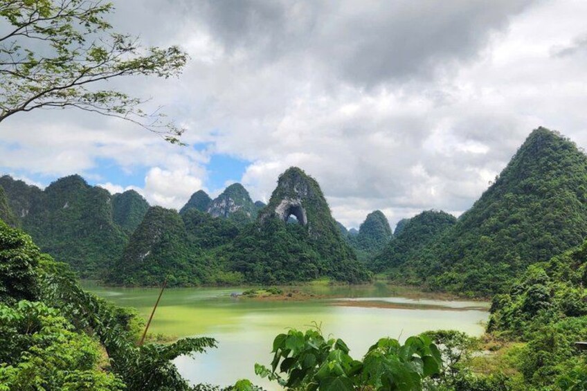 A mountainous landscape with a lake and dense greenery. 3