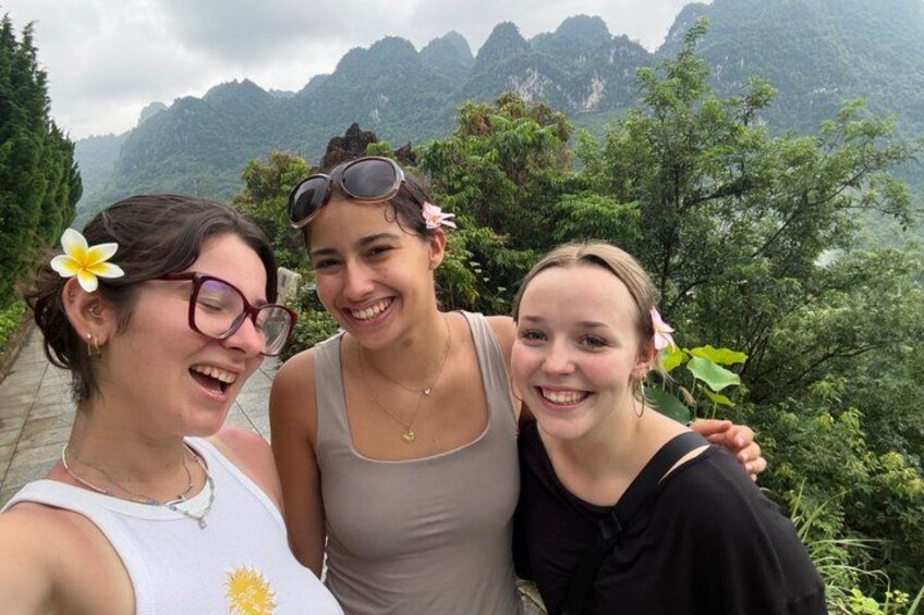 Three people posing with a mountainous landscape in the background. 5