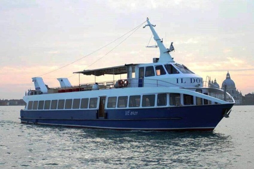 A large blue and white boat with the registration number VE 8921 on the water. 1
