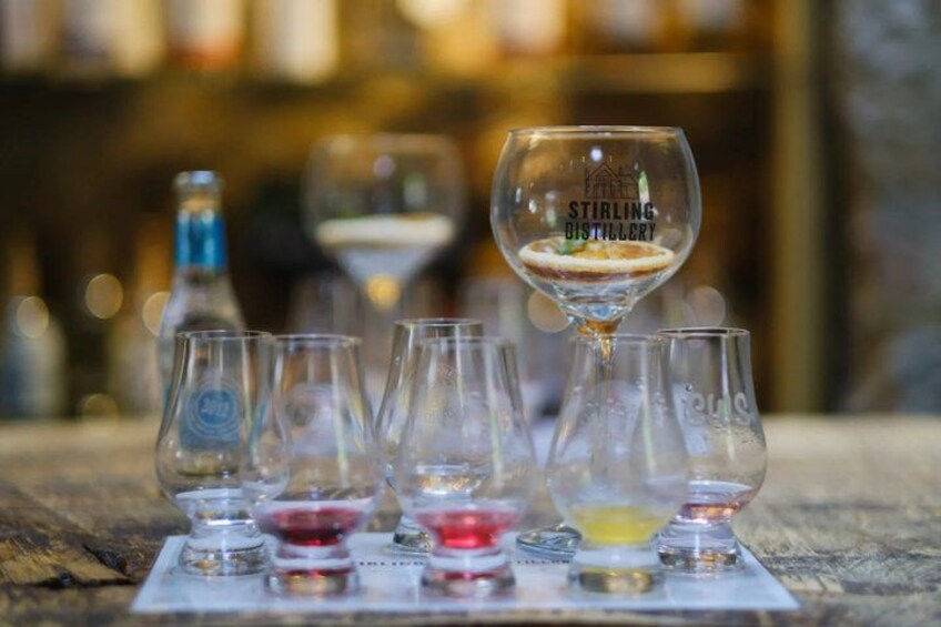 A tasting flight of wines at Stirling Distillery, with empty glasses and a bottle in the background. 1