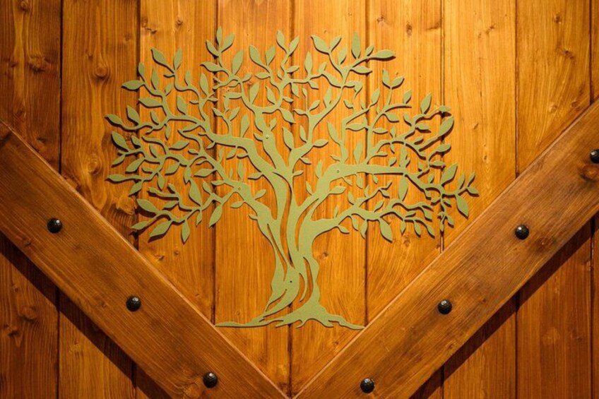 A wooden door with a tree cut-out design. 2