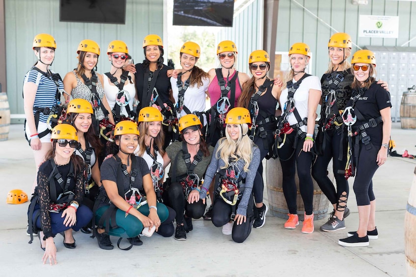 A group of people wearing helmets and harnesses, likely engaged in a climbing or rappelling activity. 5