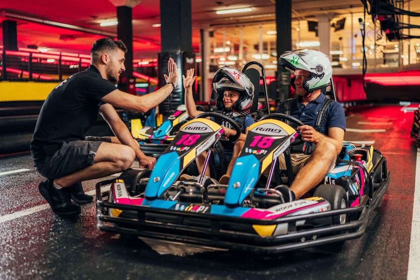 A go-kart racing scene with drivers and a coach. 3