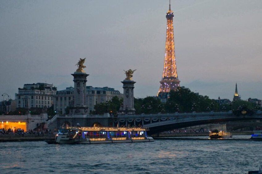 The Eiffel Tower, a river, and a bridge with statues. 3