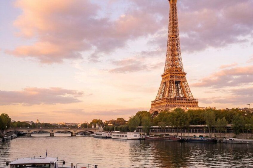 The Eiffel Tower at sunset with a river and bridges in the foreground. 1