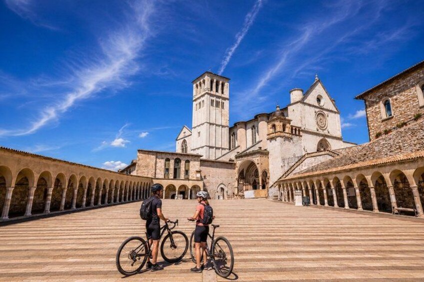A historic building with a central tower, surrounded by a covered walkway with arches. 4