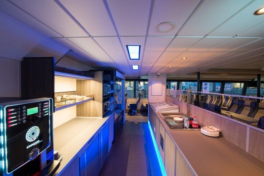 A modern indoor space with a long counter, shelves, and exercise equipment. 4