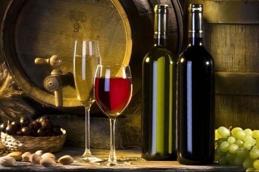 A wine barrel, two wine bottles, and a glass of red wine. 4