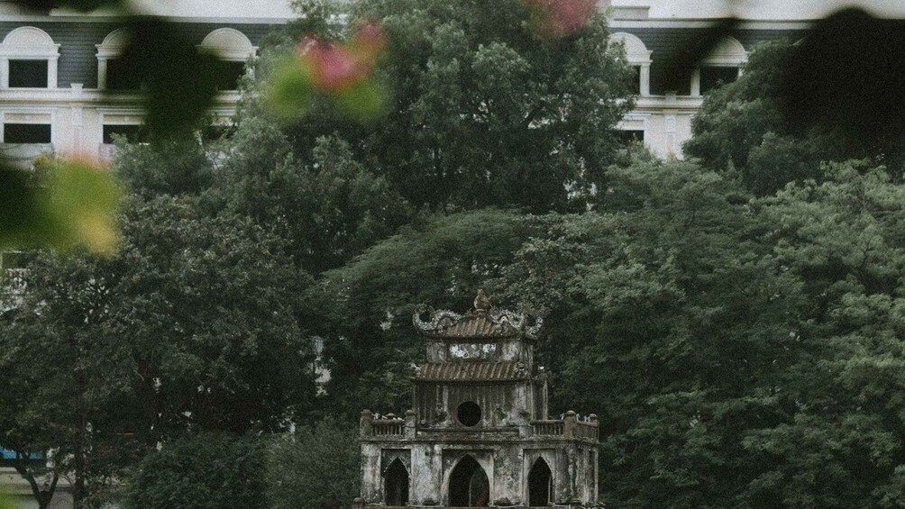 A traditional pagoda surrounded by dense foliage. 3