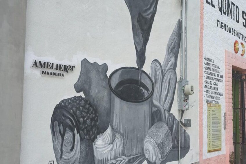A mural with a coffee cup and pastries, and the text 'AMELIER PANADERIA'. 3