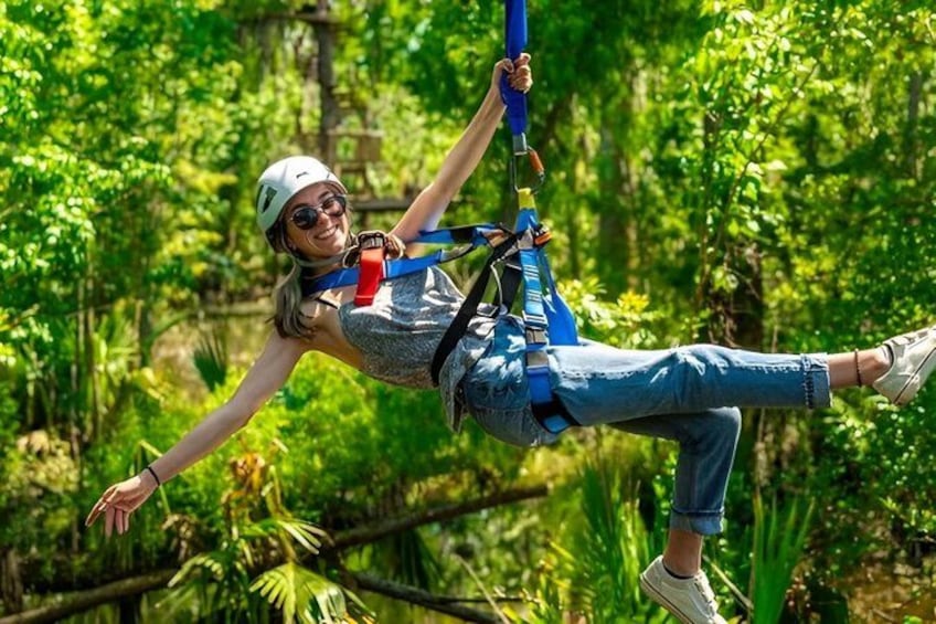A person zip-lining through a forest. 1