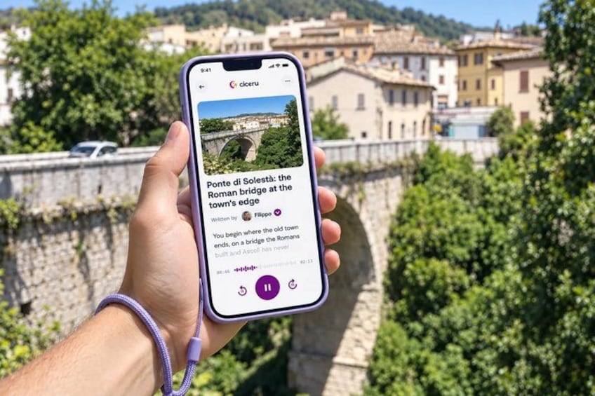 A smartphone displaying a photo of a bridge with text overlay. 1