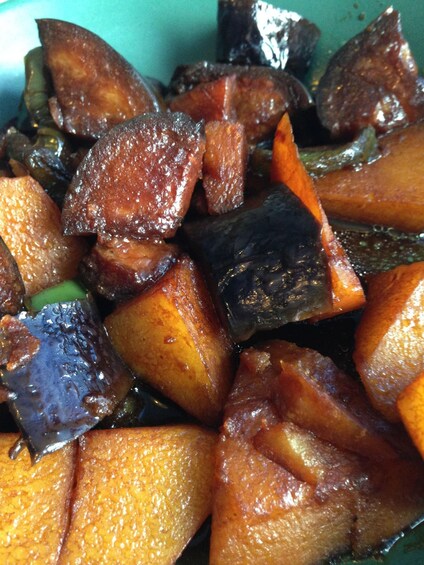 A close-up of cooked eggplant pieces with a glossy texture. 2