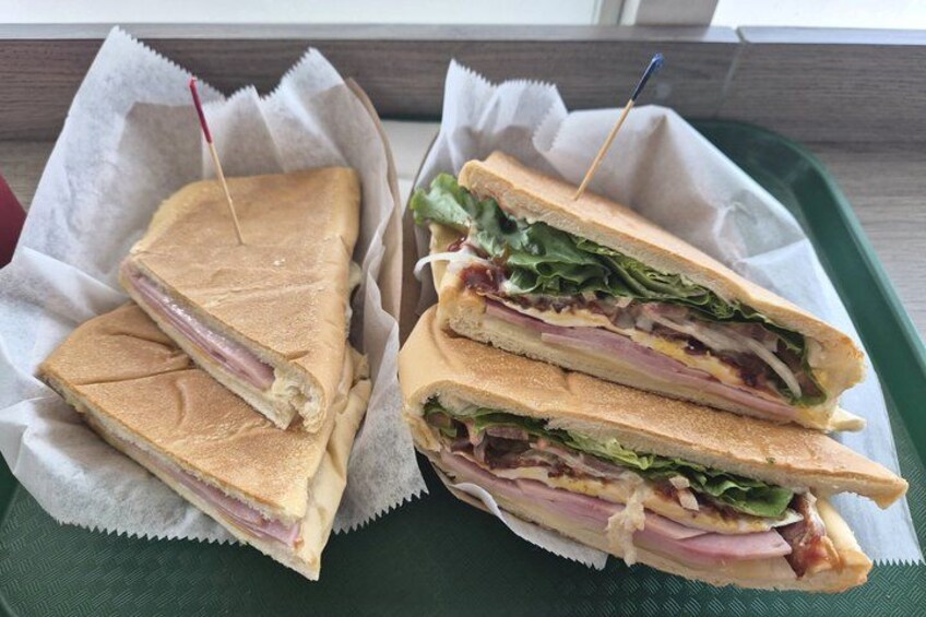 Two sandwiches on a green tray. 3