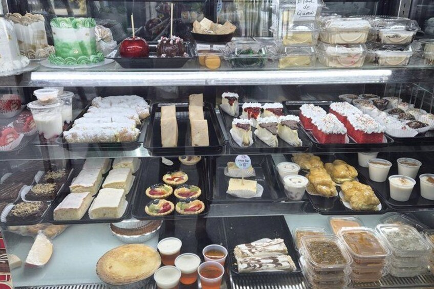 A bakery display case with various baked goods. 4