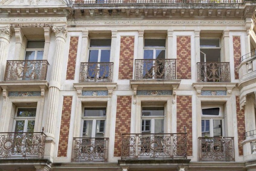 A building with ornate balconies and brickwork. 4