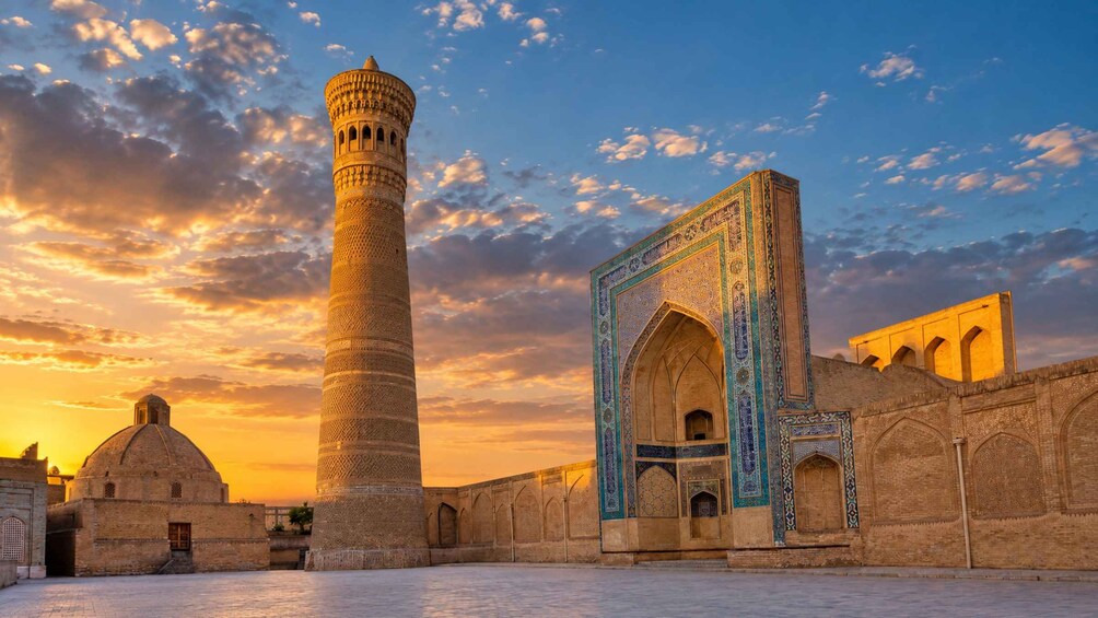 A historic building with intricate tile work, a tall minaret, and a dome. 1