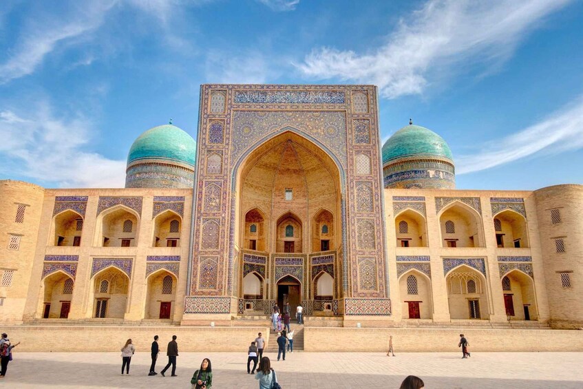A historic building with two domes and intricate tile work. 5