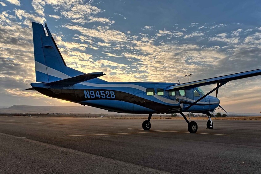 A small blue and white airplane with registration N9452B parked on a runway. 3