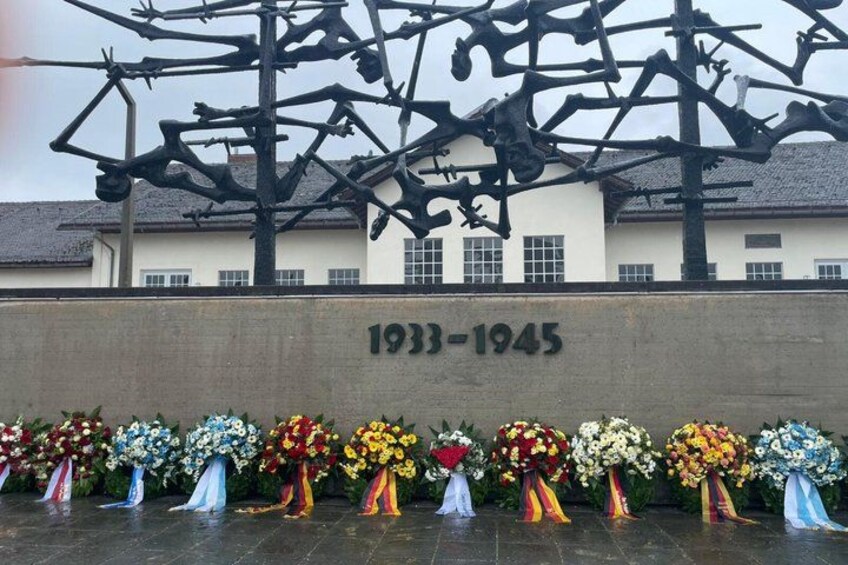 A memorial with a sculpture and flowers. 1