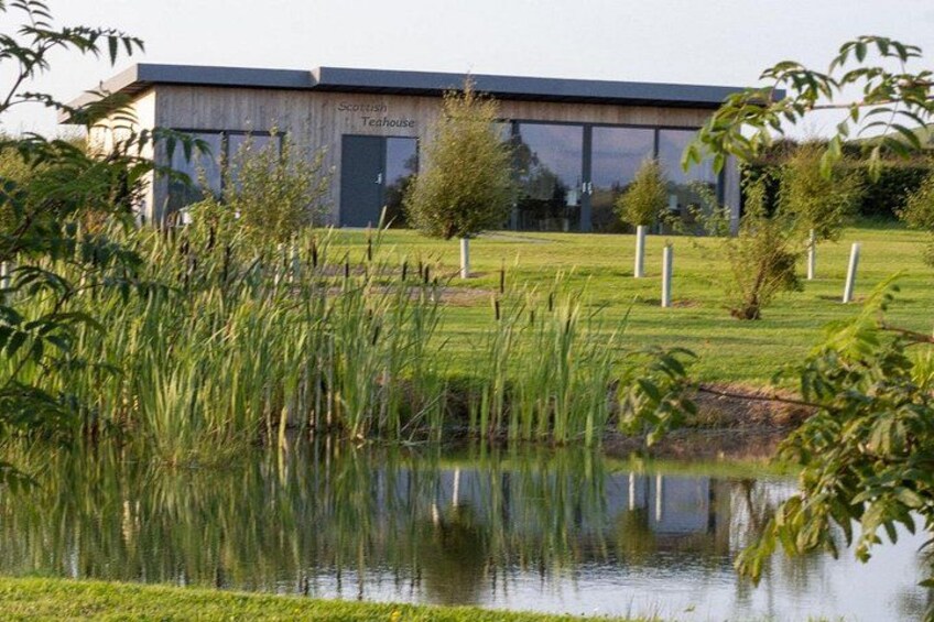 A modern building labeled 'Scottish Teahouse' with a pond and surrounding greenery. 5