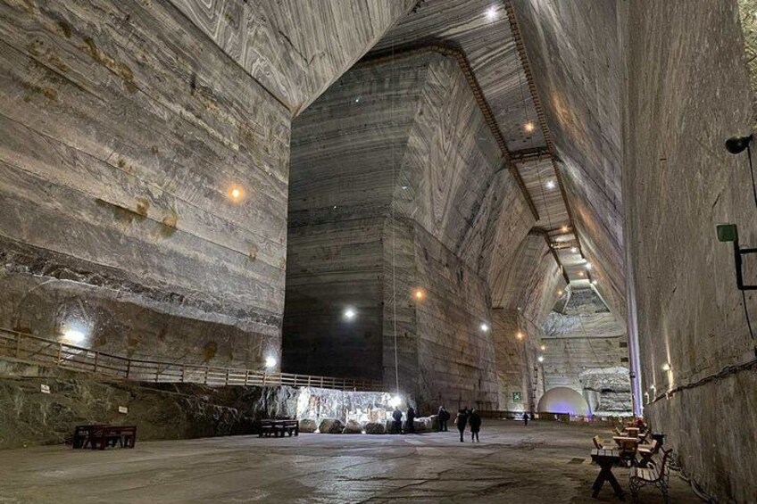 A large, cavernous interior with high ceilings and stone walls. 1