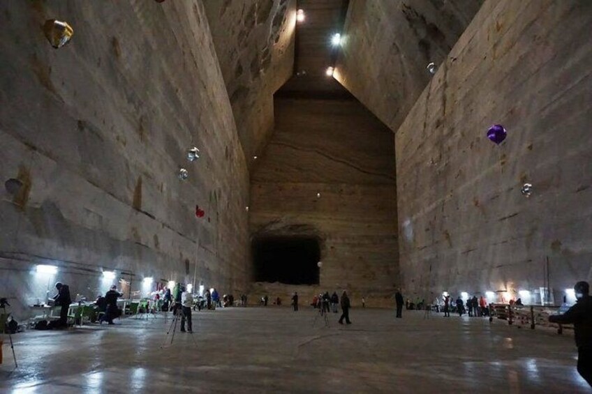 A large, open interior space with high ceilings and stone walls. 5
