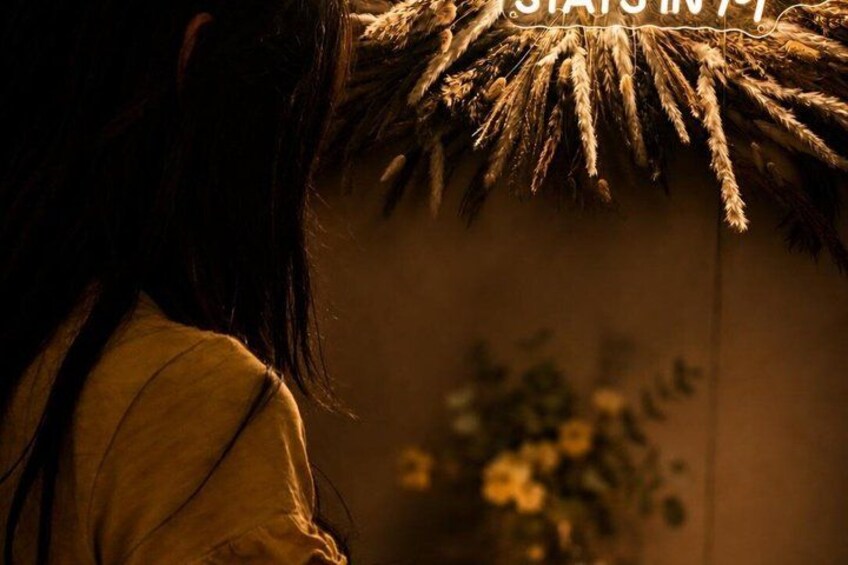 A person with a straw hat, a thatched roof, and a plant in the background. 3
