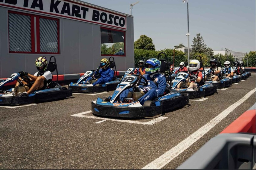 A go-kart racing event with participants in blue and white uniforms. 4