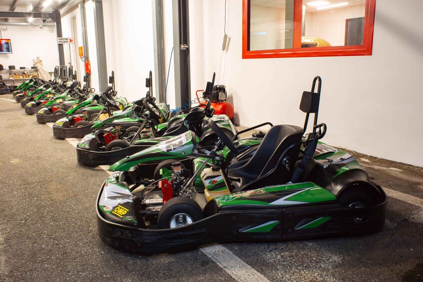 A row of go-karts parked in a garage. 5
