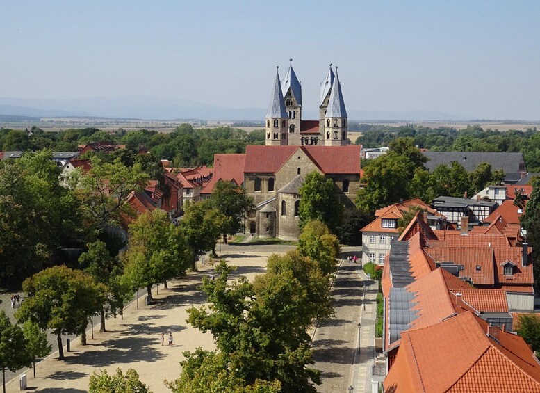 A town with a prominent church featuring two towers and a red-tiled roof. 3