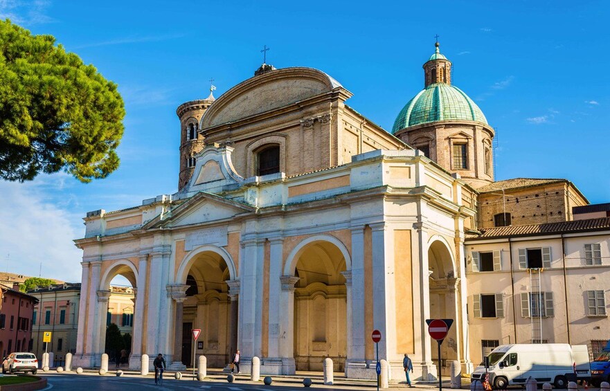 A historic church with a green dome and a bell tower. 2