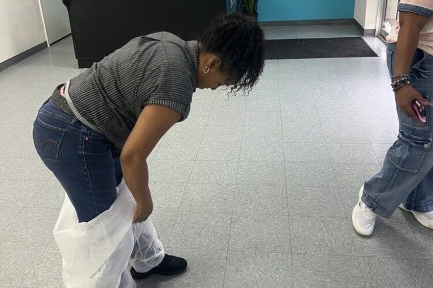 A person bending over, possibly adjusting or picking up something on the floor. 4