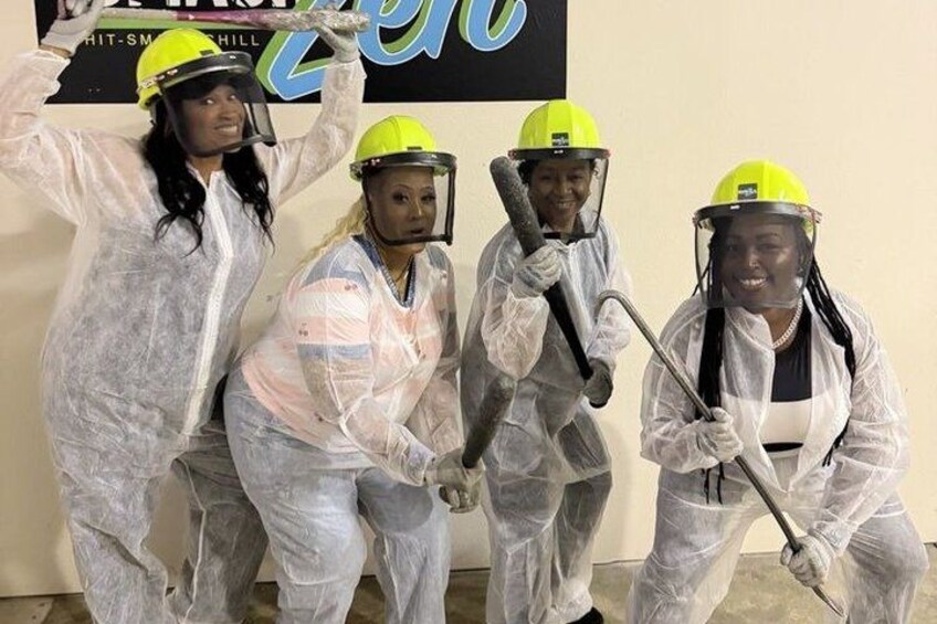 Four people in protective gear, possibly in a workshop or industrial setting. 4
