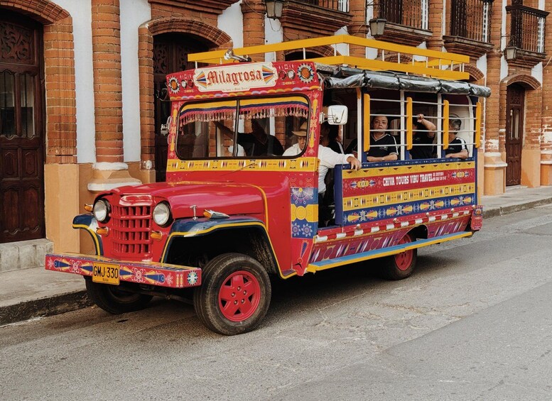 A colorful, vintage bus with 'Milagrosa' and 'Chiva Tours Vibu Travel' written on it, parked on a street. 3