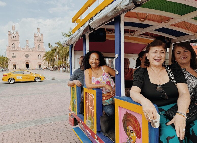 A colorful trolley with passengers, a yellow taxi, and a historic building in the background. 4