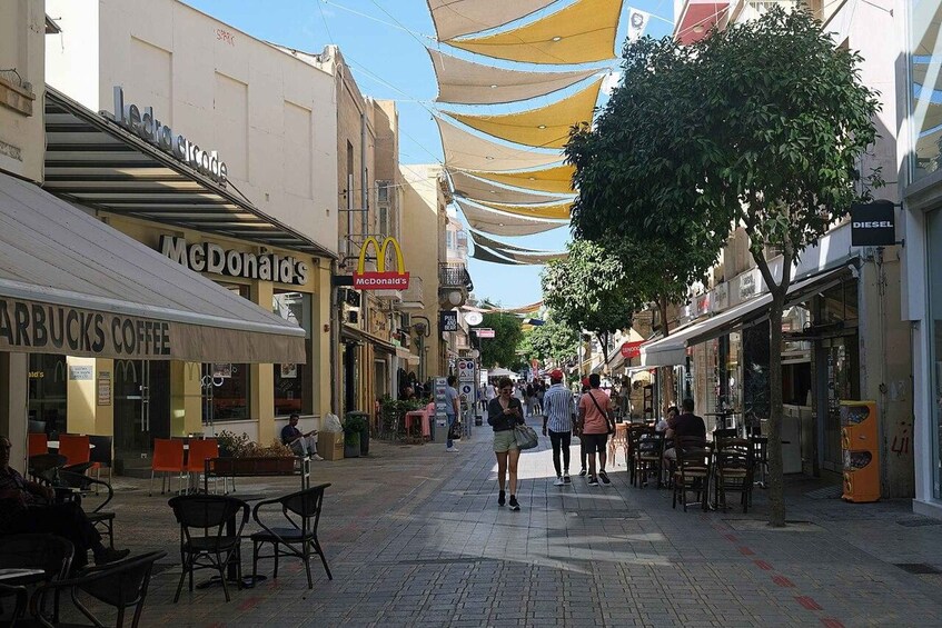 A pedestrian street lined with shops including Starbucks and McDonald's. 5
