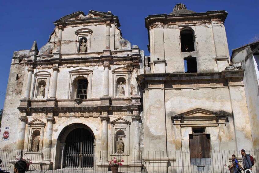 A historic church with a bell tower and a large arched entrance. 2