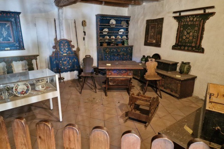 An antique shop with wooden furniture, a blue cabinet, and various decorative items. 3