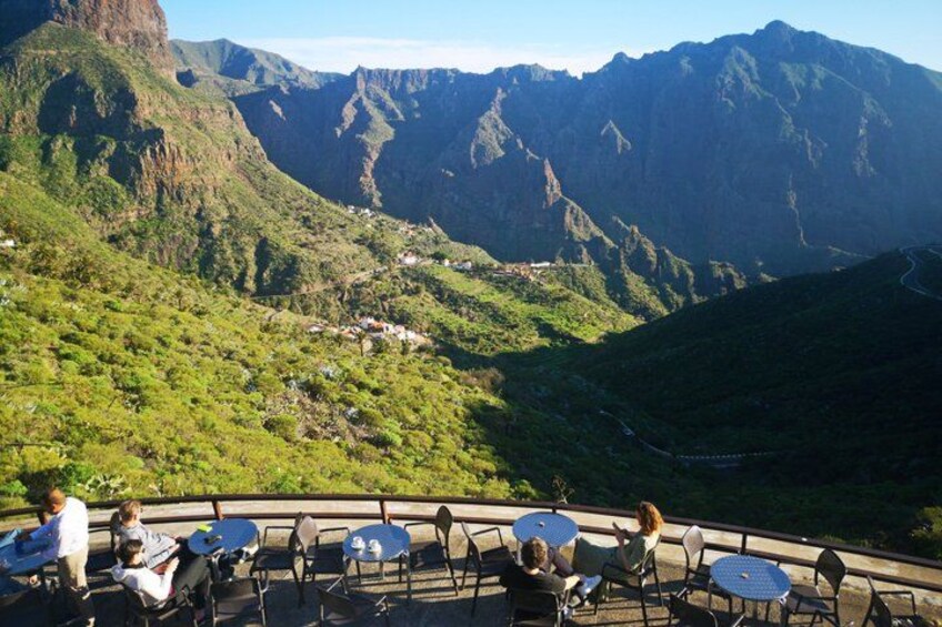 A mountainous landscape with a café overlooking the valley. 4